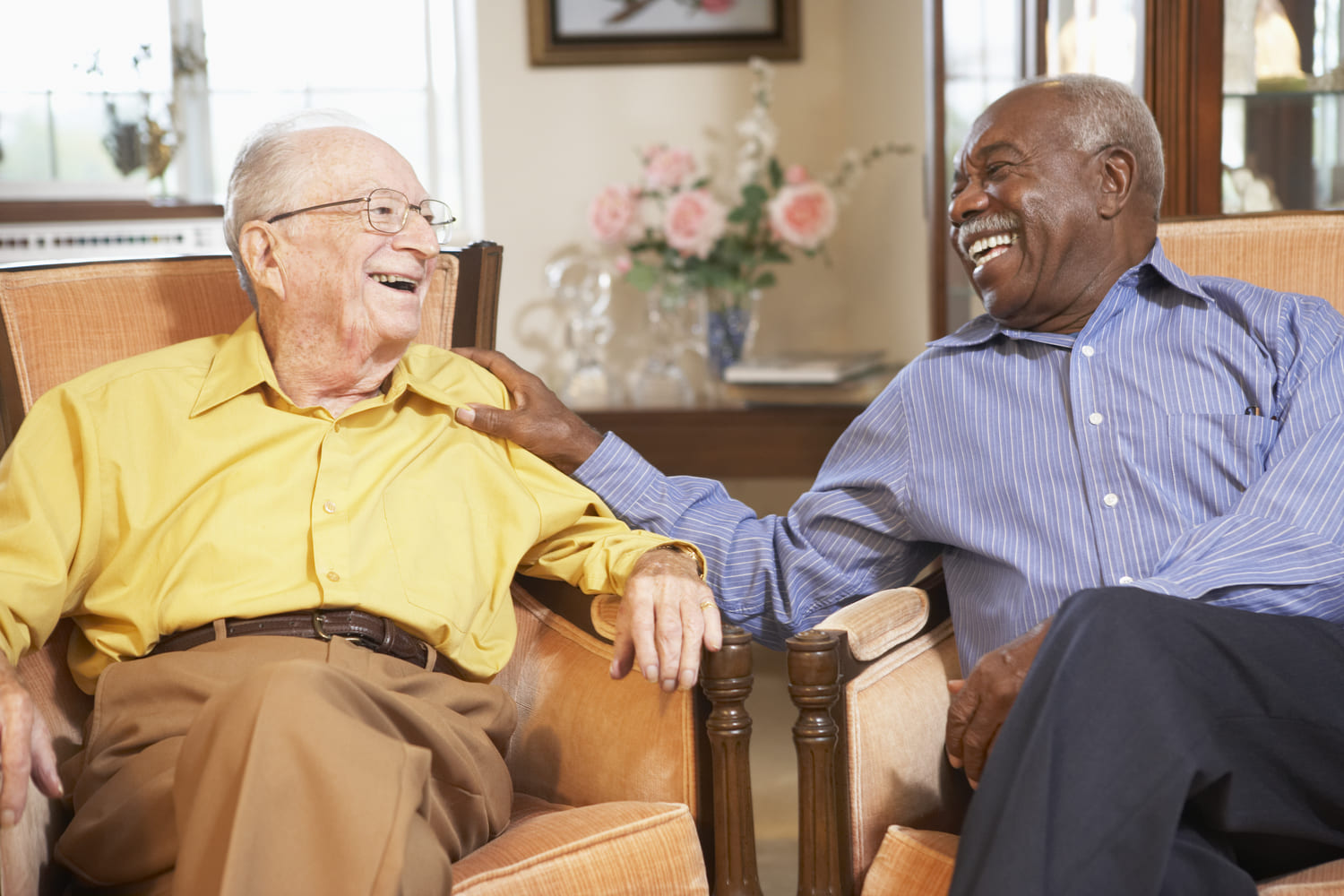 Seniors sitting on a chat while chatting