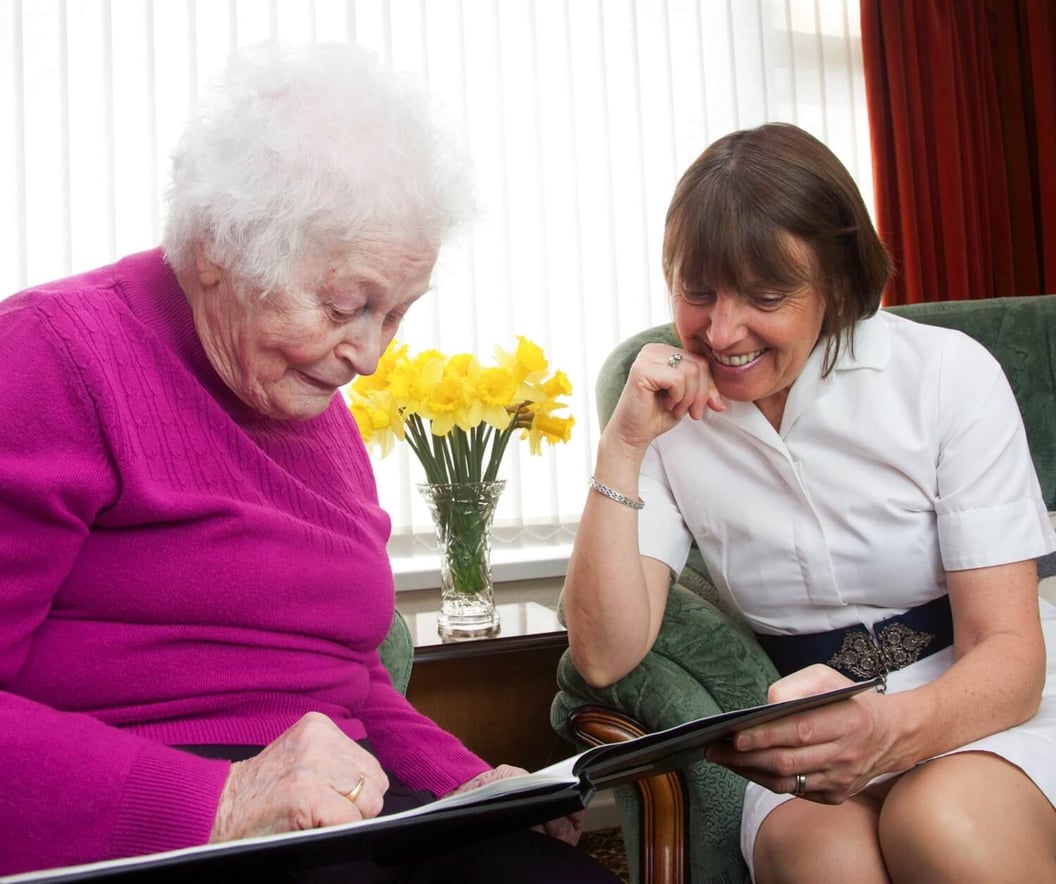 caregiver visiting and caring for an elderly woman