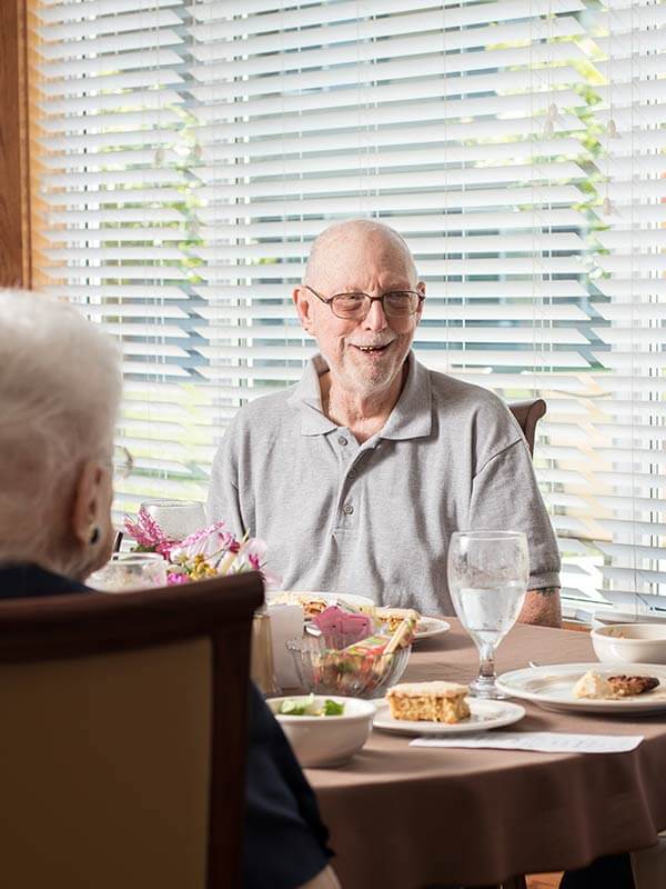 Senior Man Eating At Table