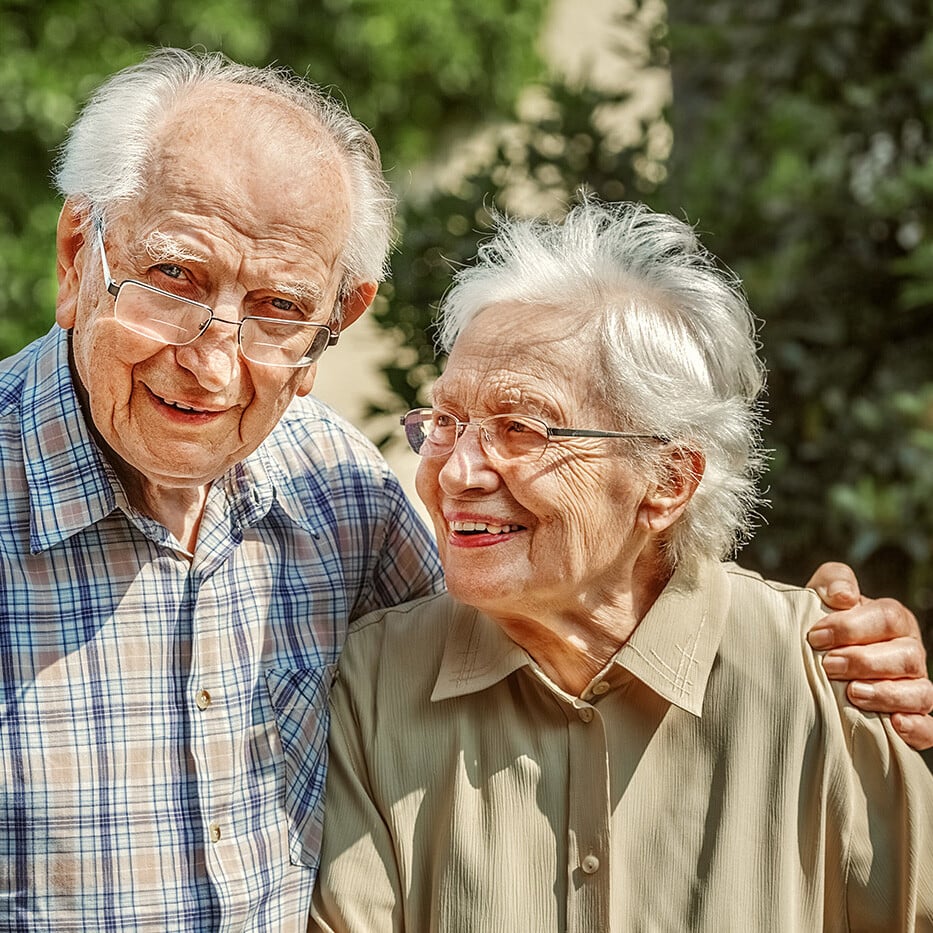 Smiling senior couple embracing outdoors