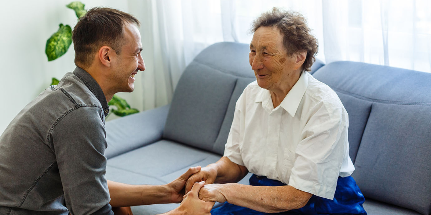 Caregiver holding resident's hands