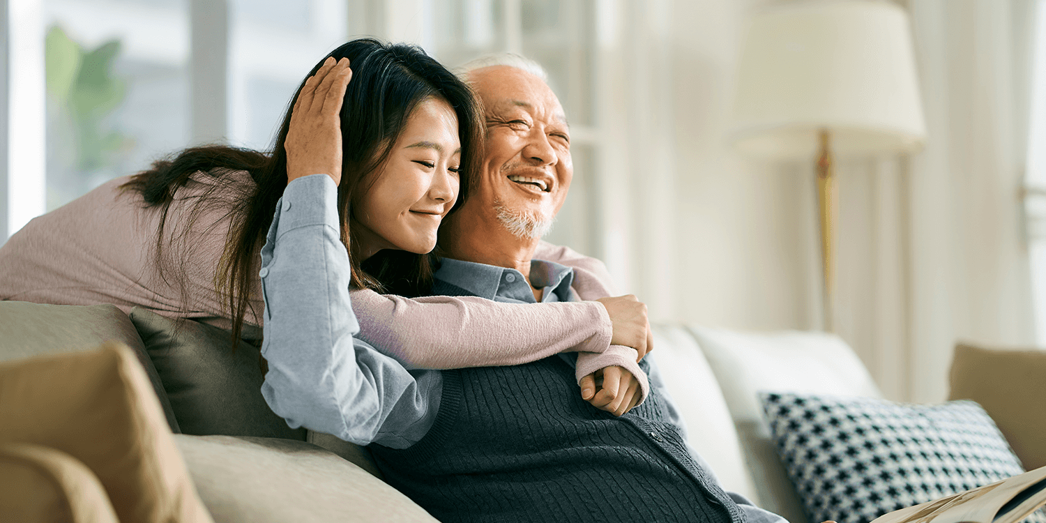 father and daughter embracing at senior living community