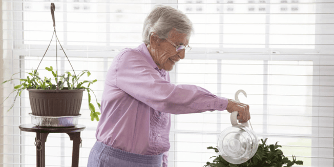 Senior community resident watering plants