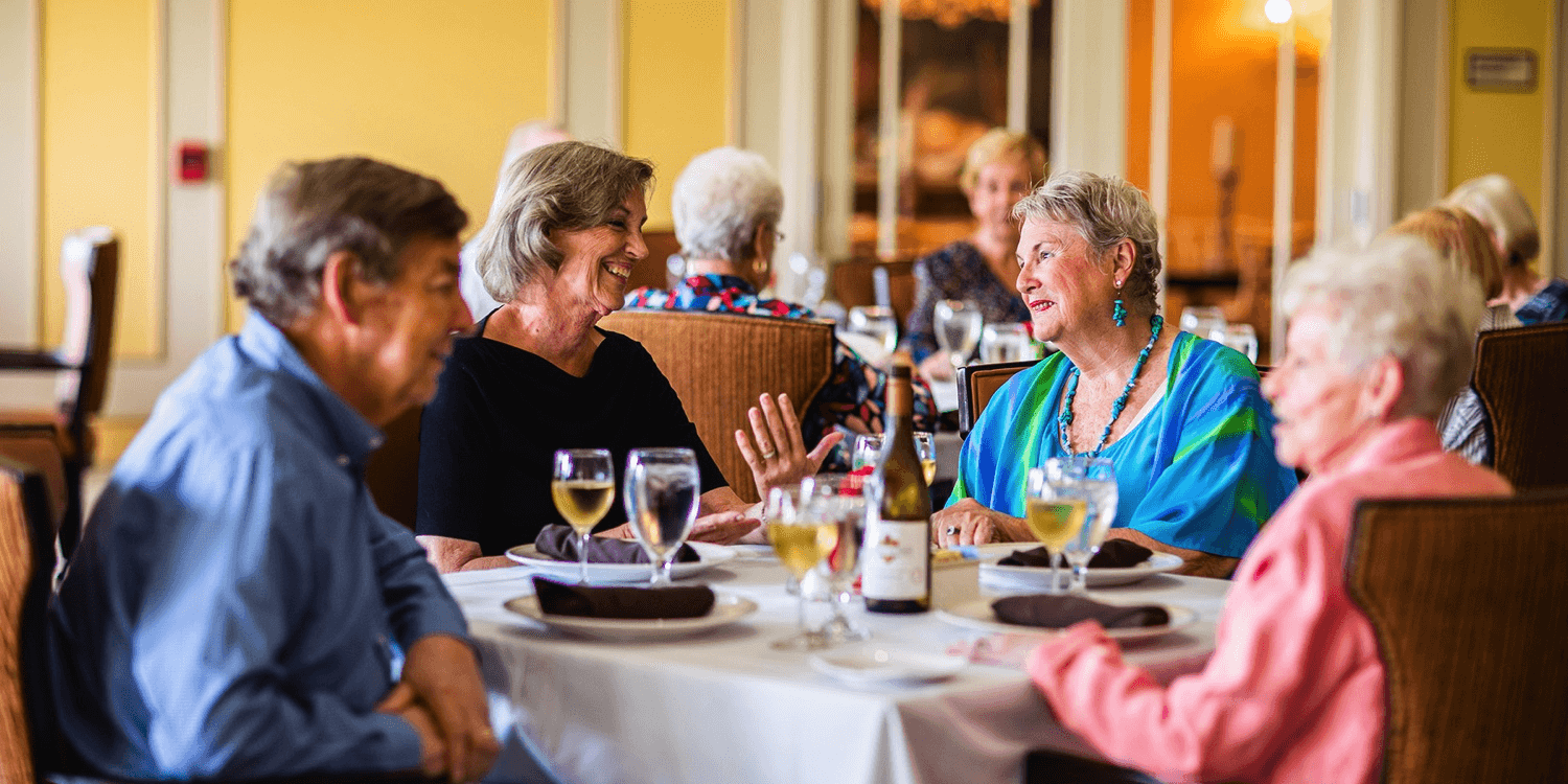 Senior friends enjoying a meal at a Cedarhurst Senior Living community