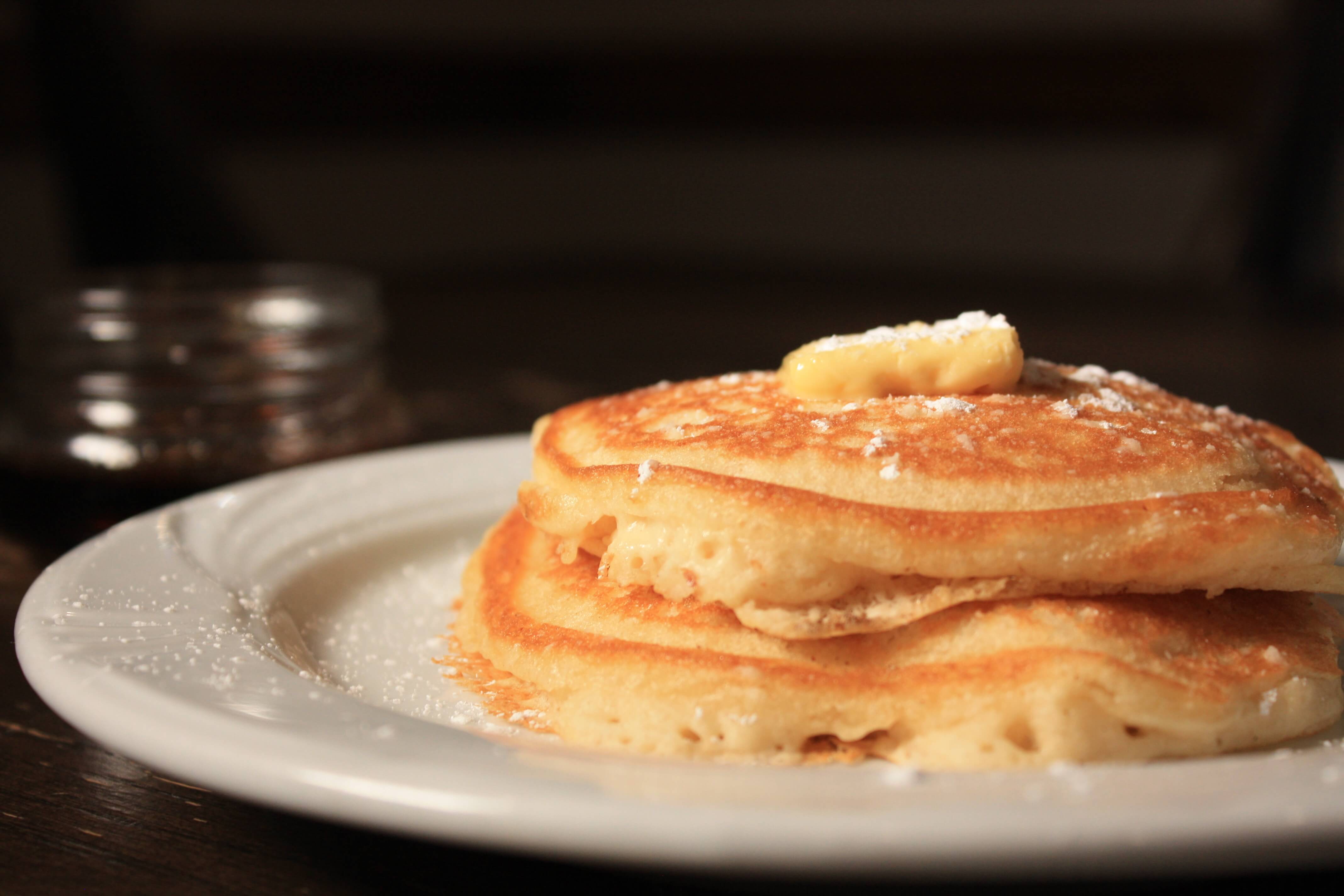 Plate with pancakes and butter on top