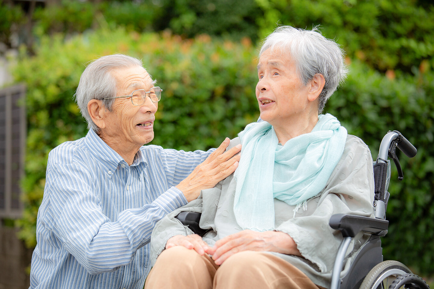 Senior man with wife in a wheelchair