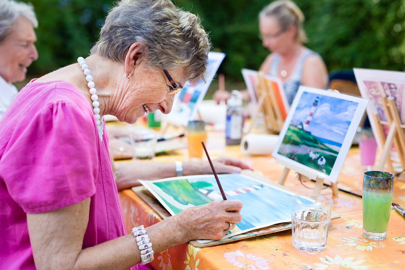 seniors in painting class at senior living community