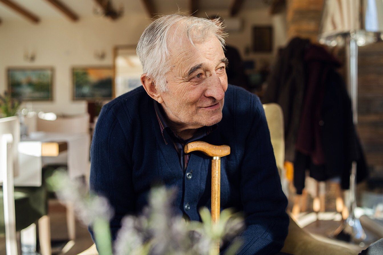 senior man sitting in dining room