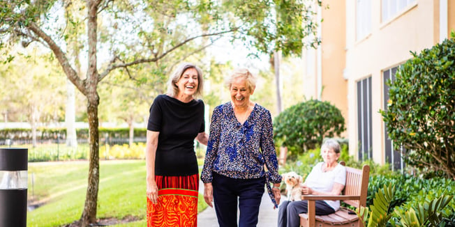 Senior living community residents engaging in a happy conversation