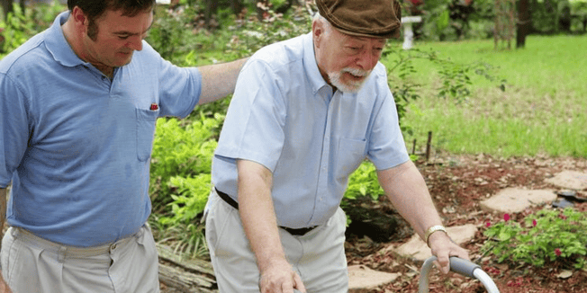  A Cedarhurst team member helping a senior resident with a walker