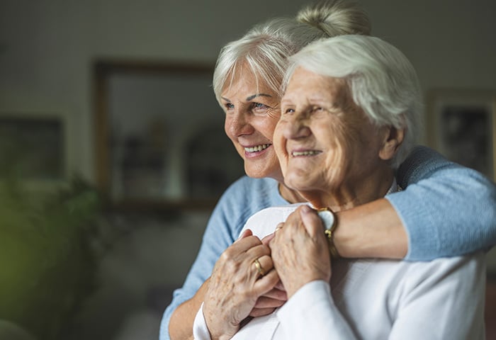 Daughter of a memory care resident embracing her mother